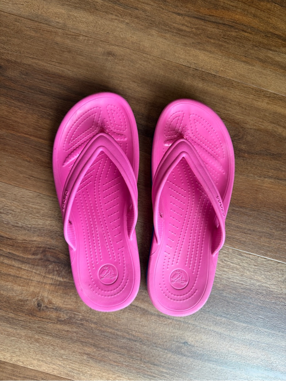 CROCS Bright Pink Flip Flops with Blue Side Stripes